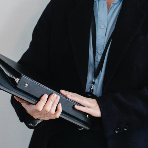 a woman holding some binders