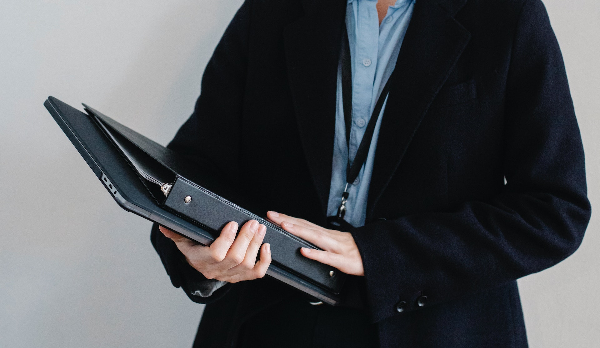 a woman holding some binders