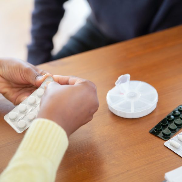 a care aid getting out pills for a senior