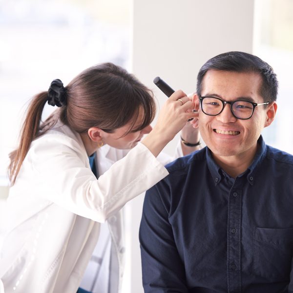 Neil Squire Hearing Solutions Audiologist Heather conducting a hearing exam with a client