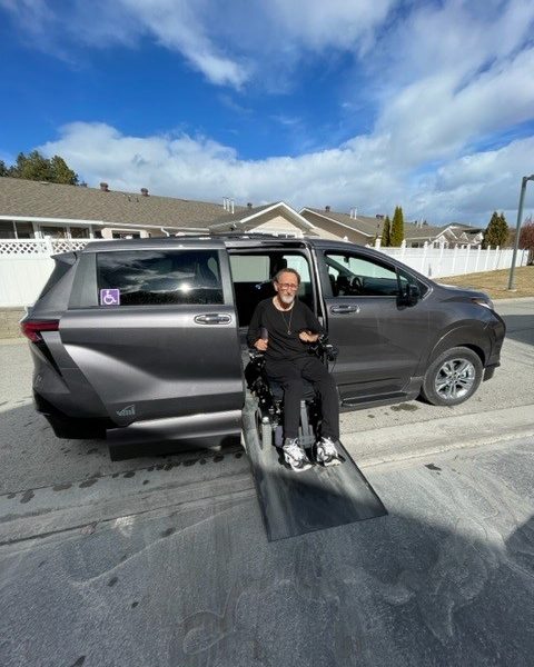 WorkBC Assistive Technology Services participant Kelly coming down a ramp from his wheelchair accessible van