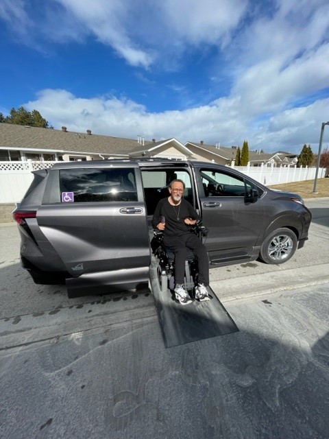 WorkBC Assistive Technology Services participant Kelly coming down a ramp from his wheelchair accessible van