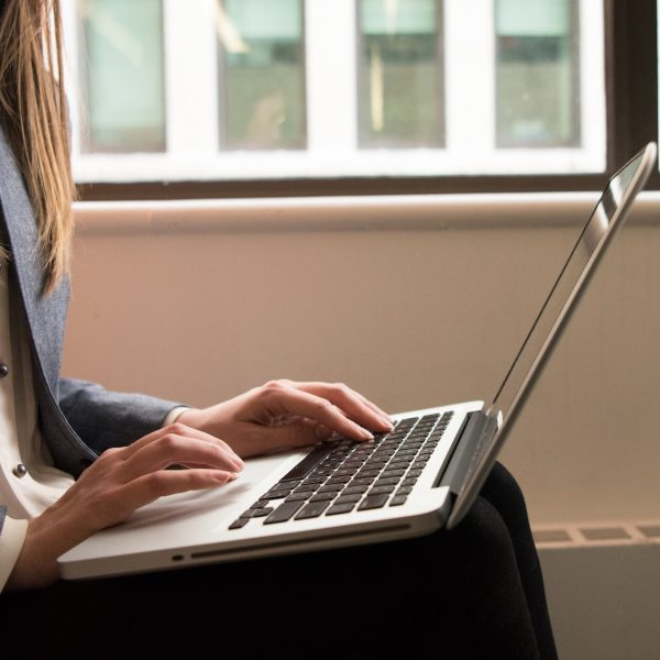 a woman typing on the computer