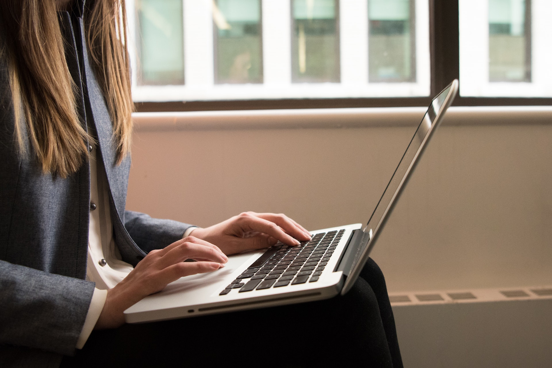 a woman typing on the computer