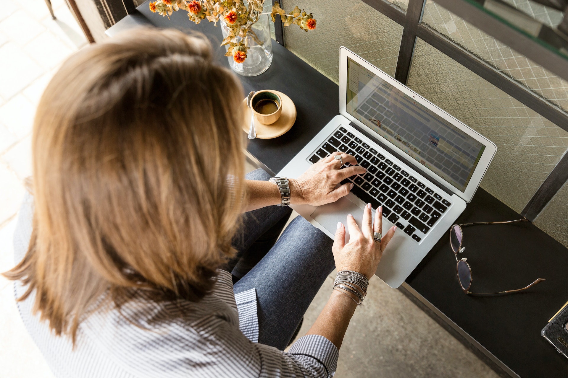 A woman using a laptop.