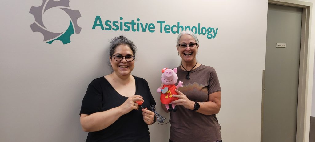 Solutions staff holding up a Peppa Pig toy they adapted.