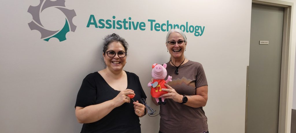 Solutions staff holding up a Peppa Pig toy they adapted.