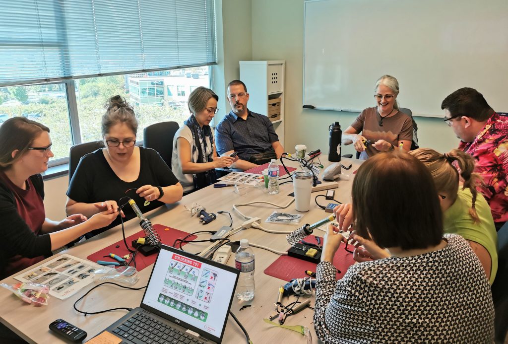 The Solutions team hard at work adapting toys with the help of Makers Making Change.