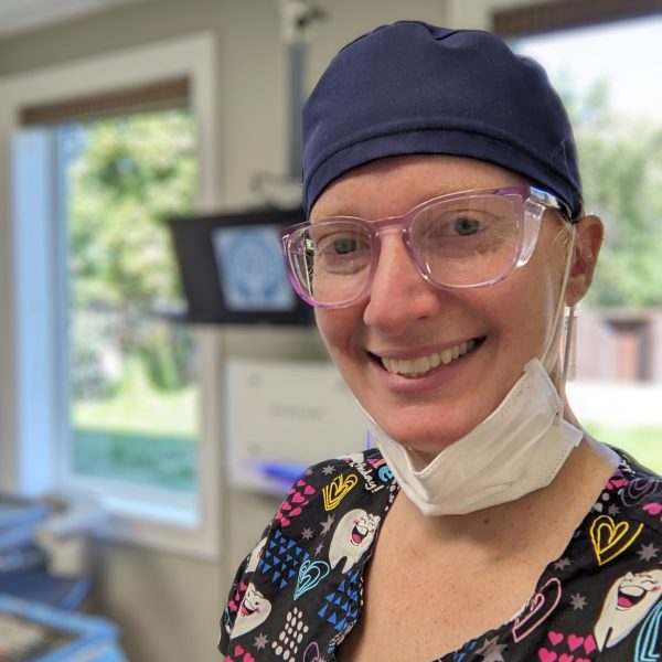 WorkBC Assistive Technology Services participant Amy, wearing a surgical mask and cap.