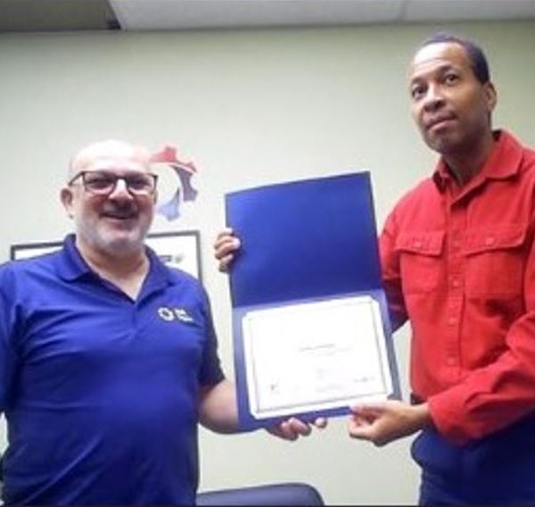 Alain (right) presenting Charles (left) with the award.