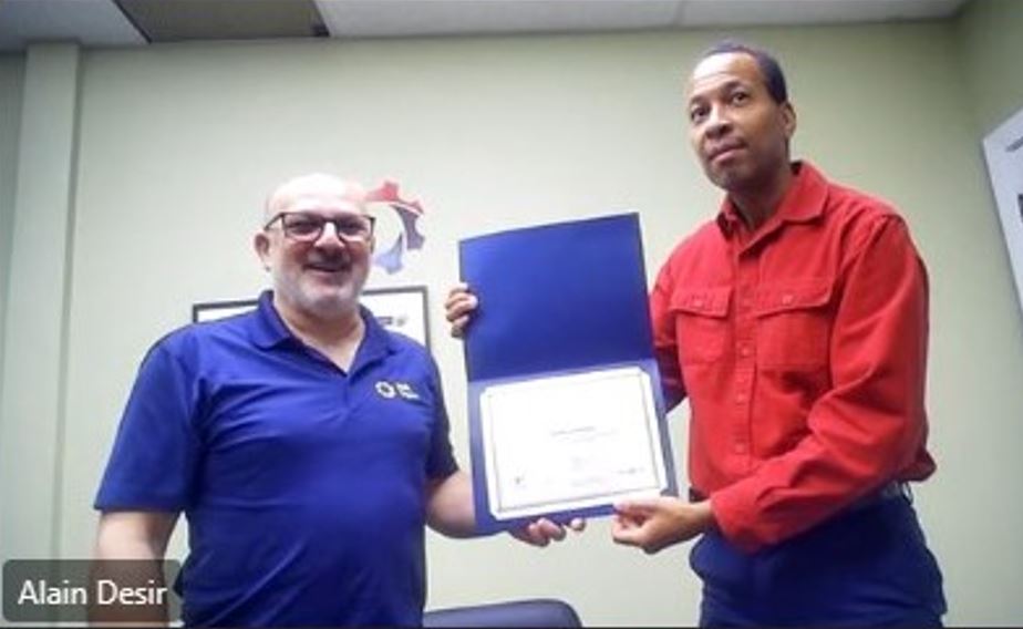 Alain (right) presenting Charles (left) with the award.