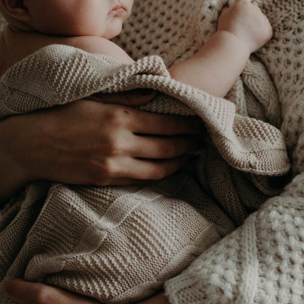 A mother embracing a baby.