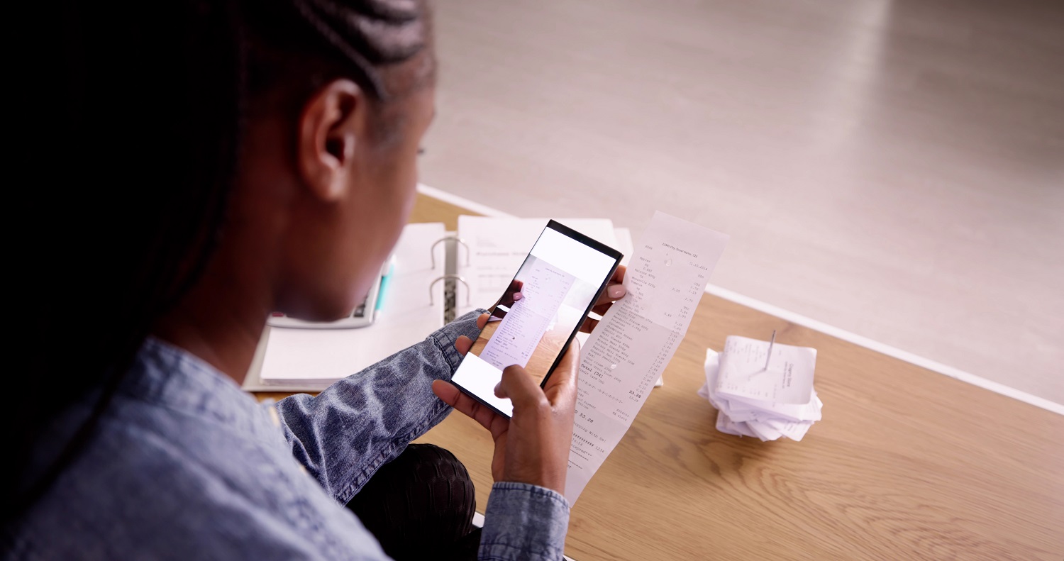 A person scans a receipt with their phone.