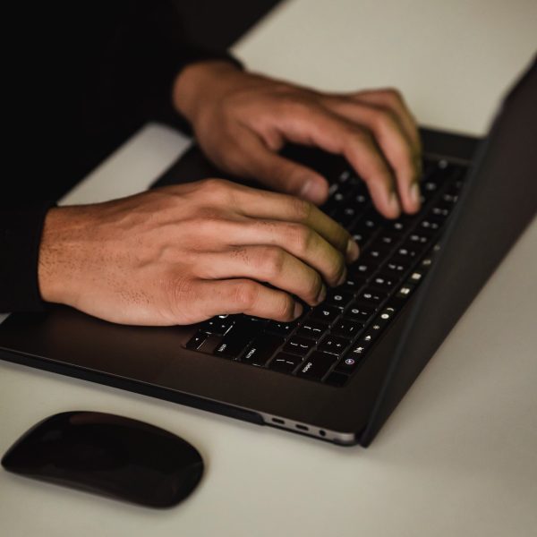 A person types on a laptop.