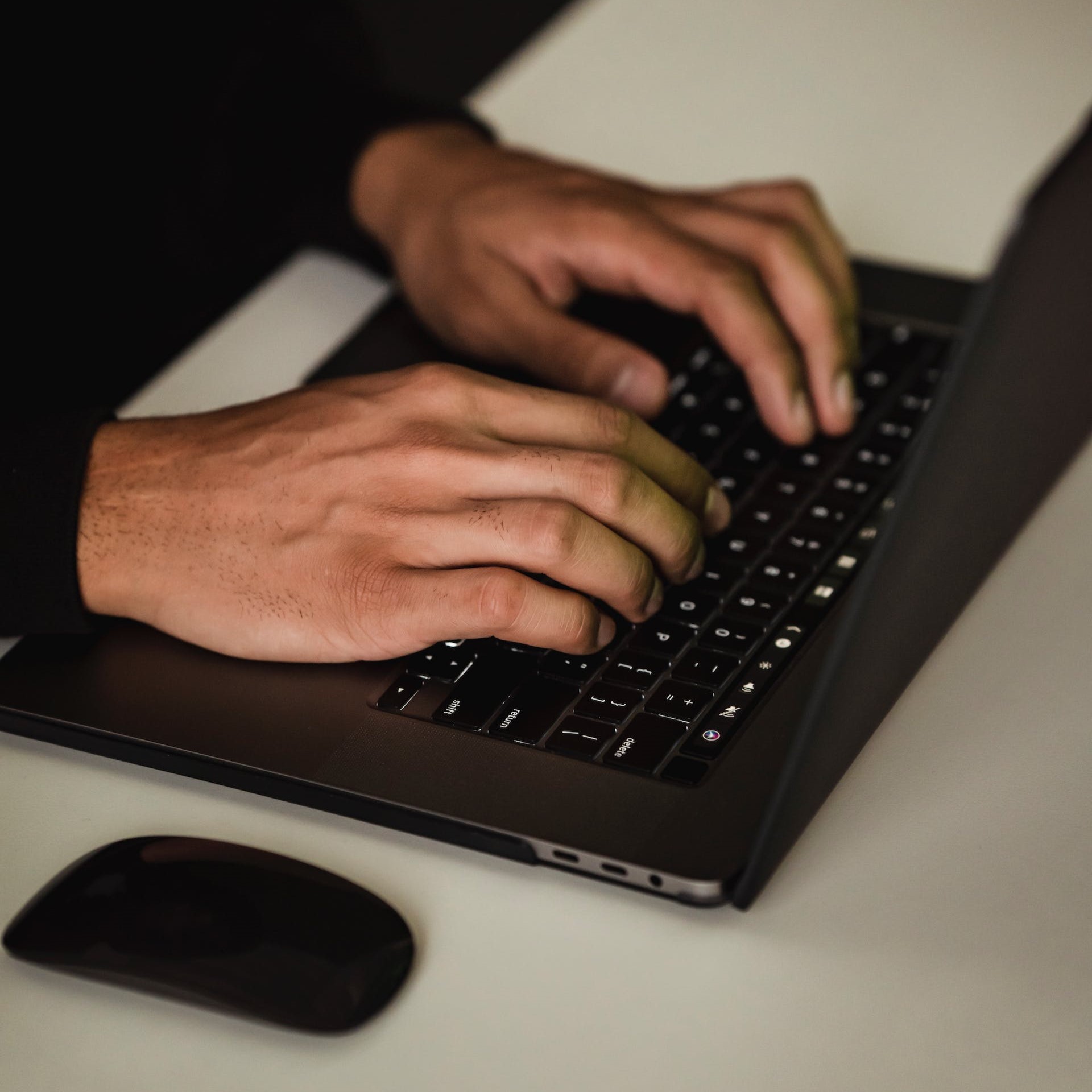 A person types on a laptop.