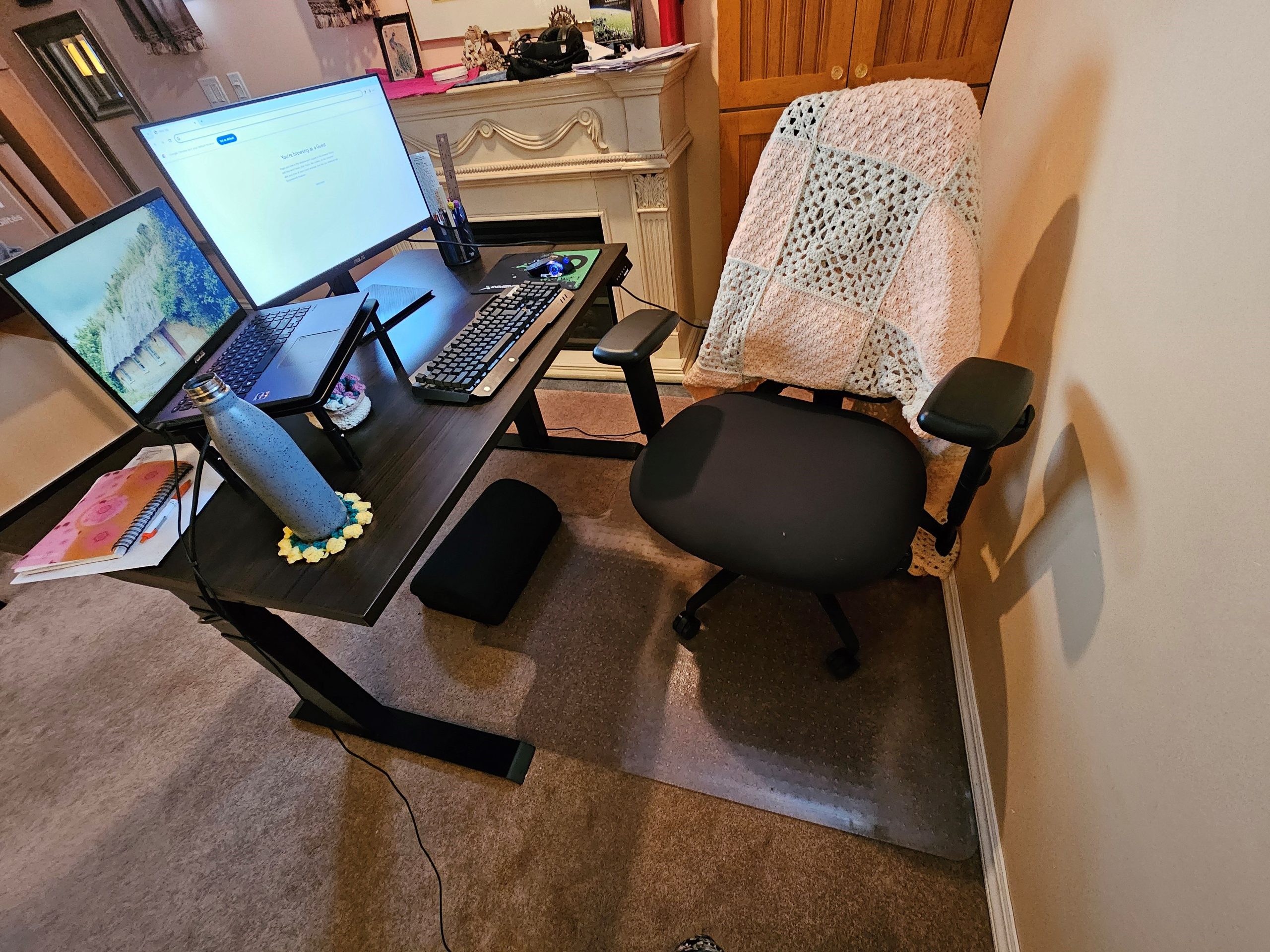 Michelle's workstation, featuring her adjustable chair, sit/stand desk, laptop riser, monitor, and other ergonomic supports.