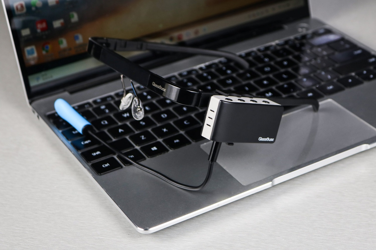 A GlassOuse headset sitting on a laptop.