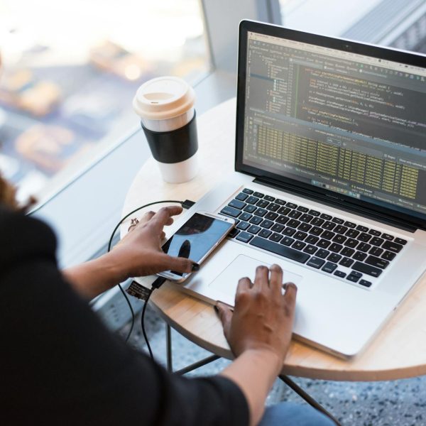 A woman does some coding on her laptop.