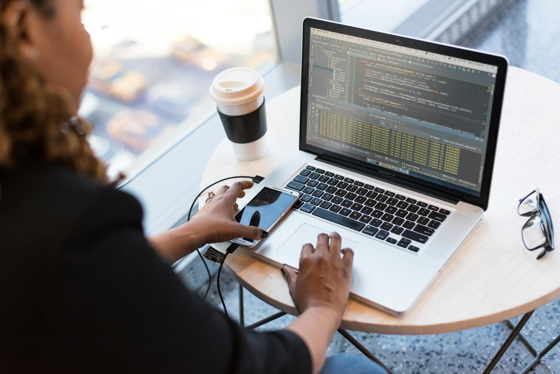 A woman does some coding on her laptop.