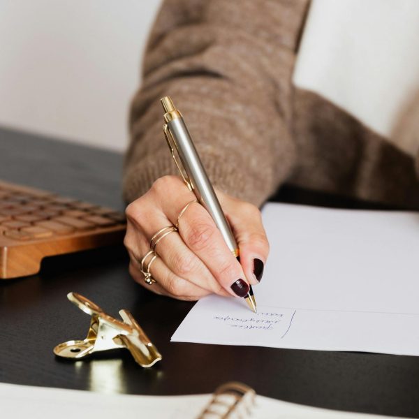 A woman writes on a piece of paper.