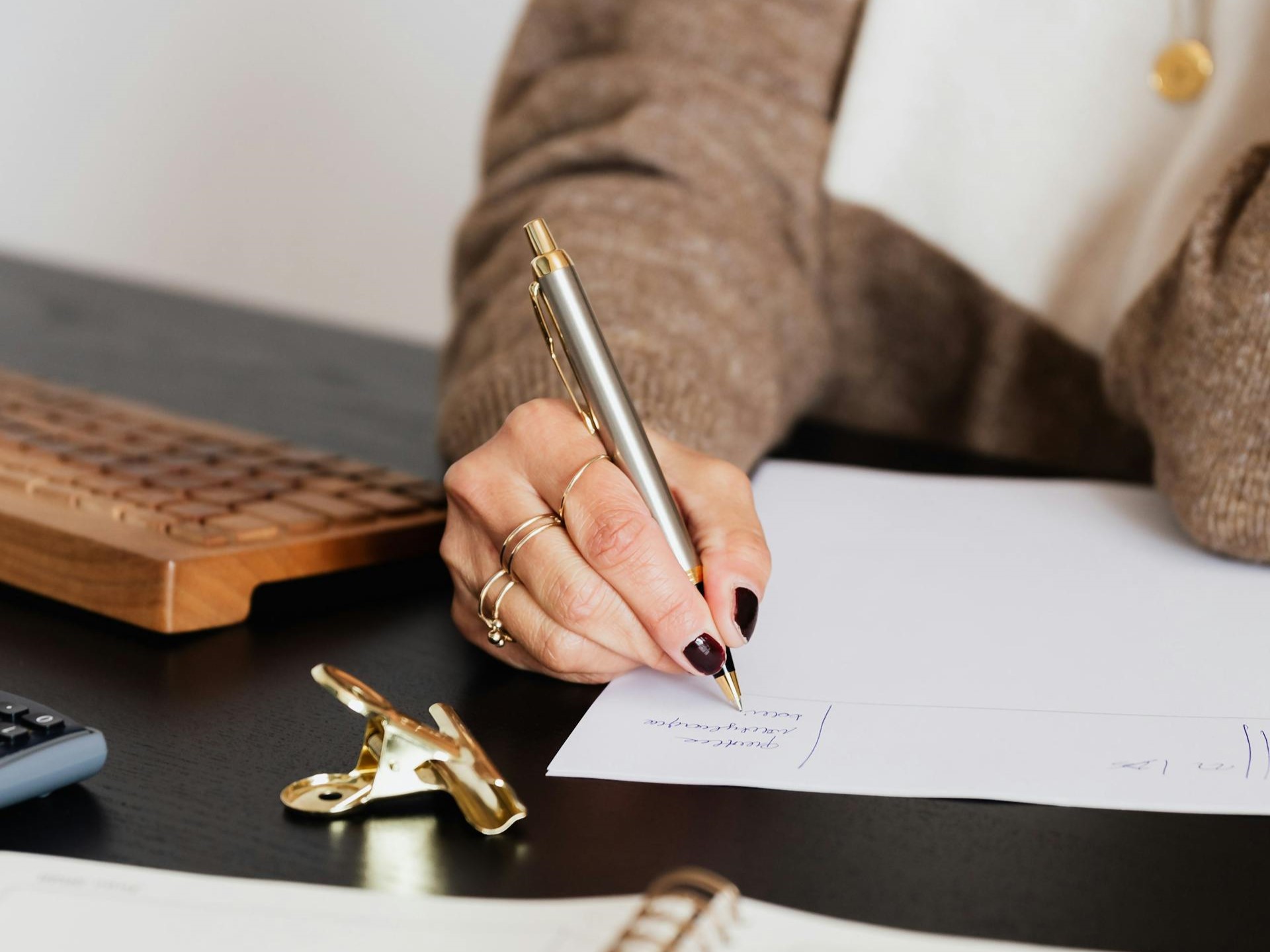 A woman writes on a piece of paper.