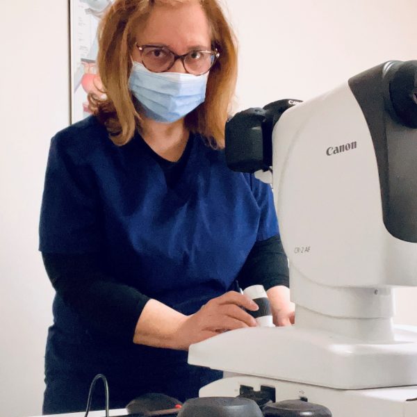 Tracy using a fundus camera at work.