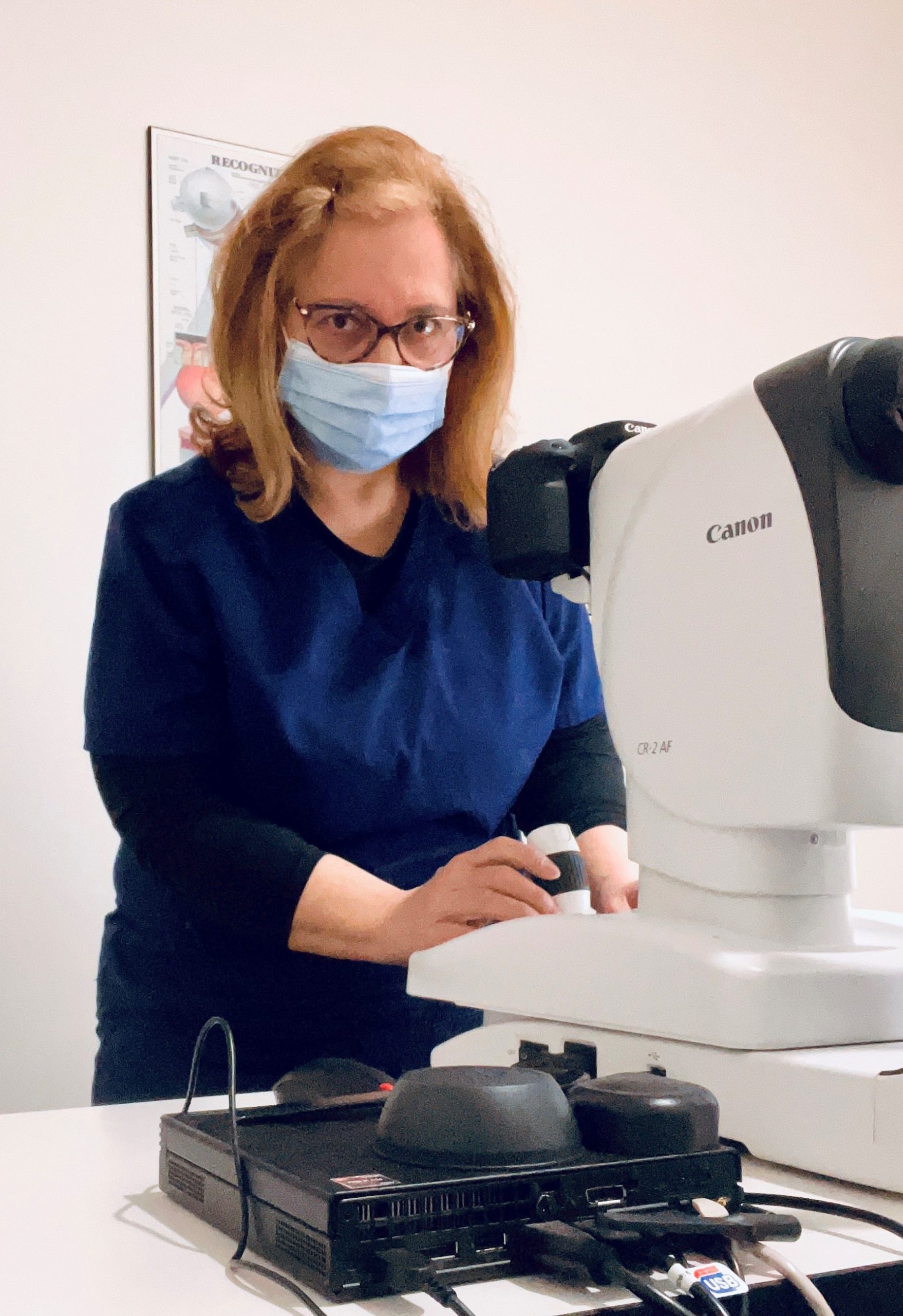 Tracy using a fundus camera at work.