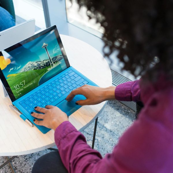 A woman typing on a laptop.