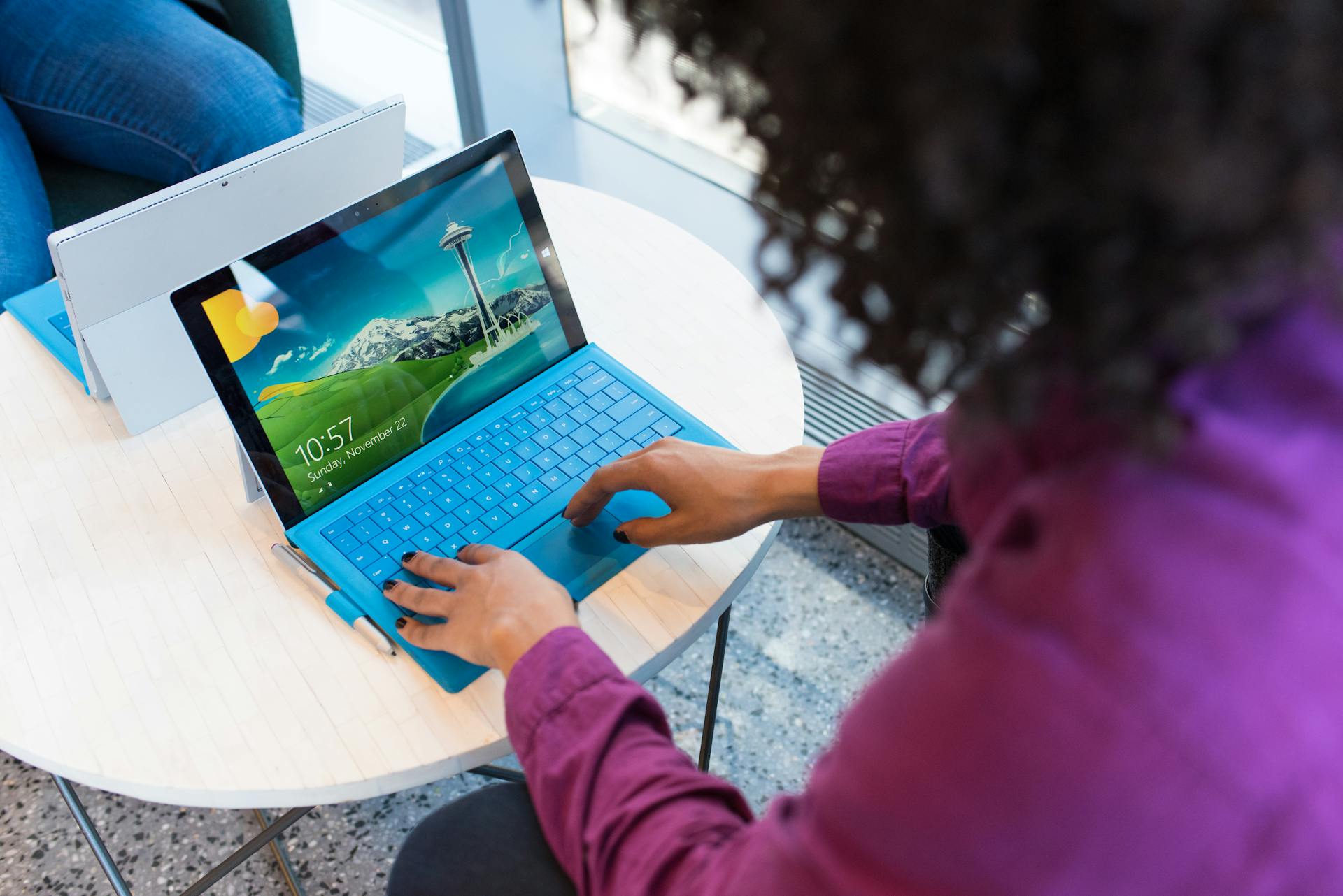 A woman typing on a laptop.