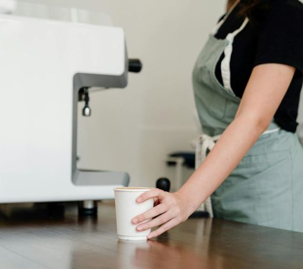 A barista serves coffee.