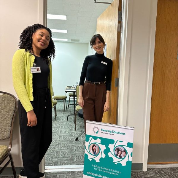 Candide and Heather next to a Hearing Solutions banner.