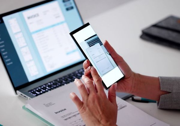A person uses a phone to scan a document.