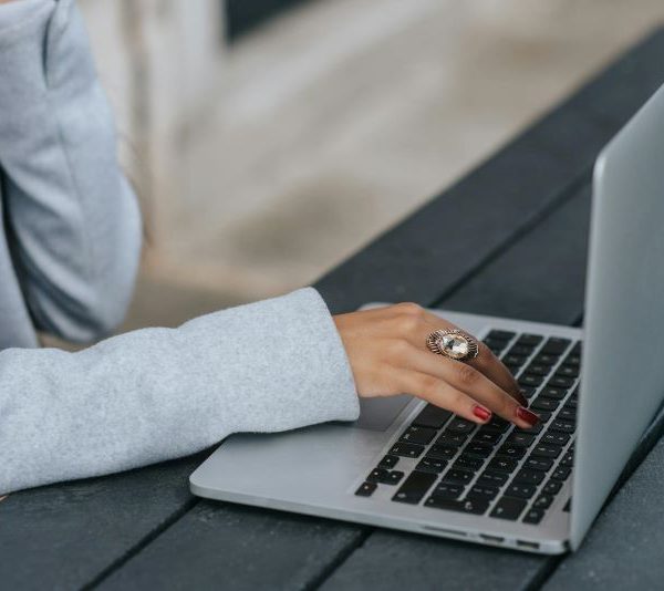 A woman types on a laptop.