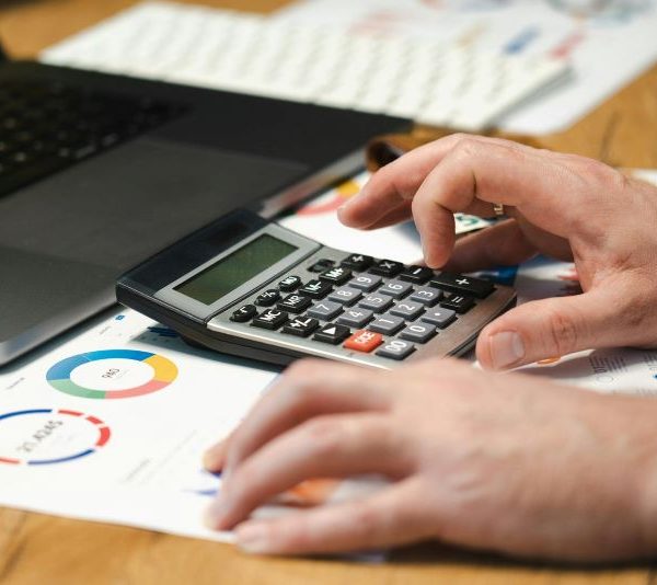A person uses a calculator while they work.