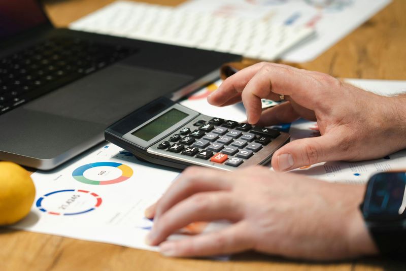 A person uses a calculator while they work.