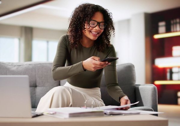 A woman uses her phone to scan some documents.