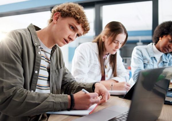 Youth studying together at a round table.