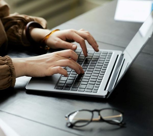 A person typing on a laptop.
