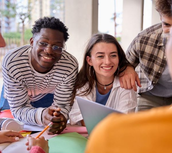 Postsecondary students work together on a group project.