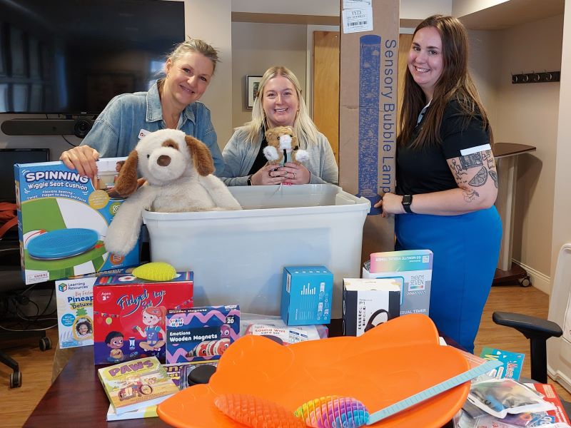 Chelsea, Amanda, and clinicians during a kit delivery.