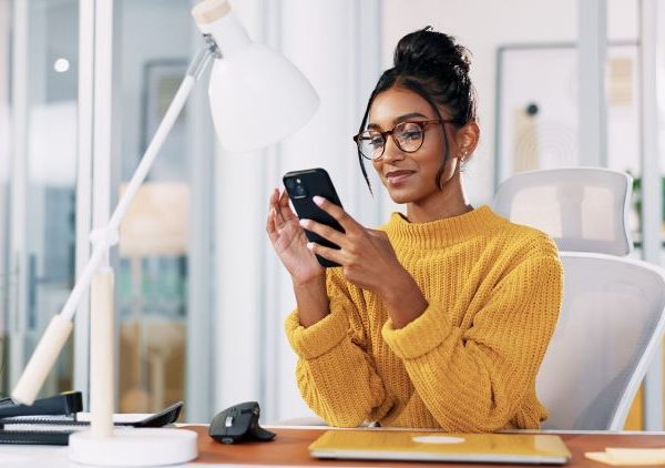 A woman uses a smartphone.