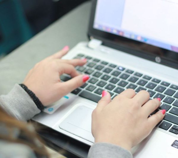 A woman works on a laptop.