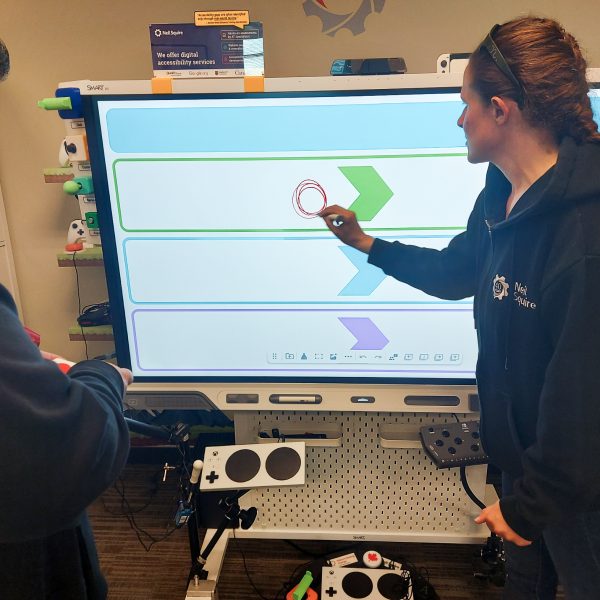 Gordon and Jody work together with a SMART Board.